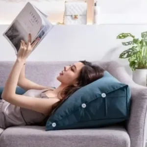 Femme lisant avec un coussin de lecture triangulaire